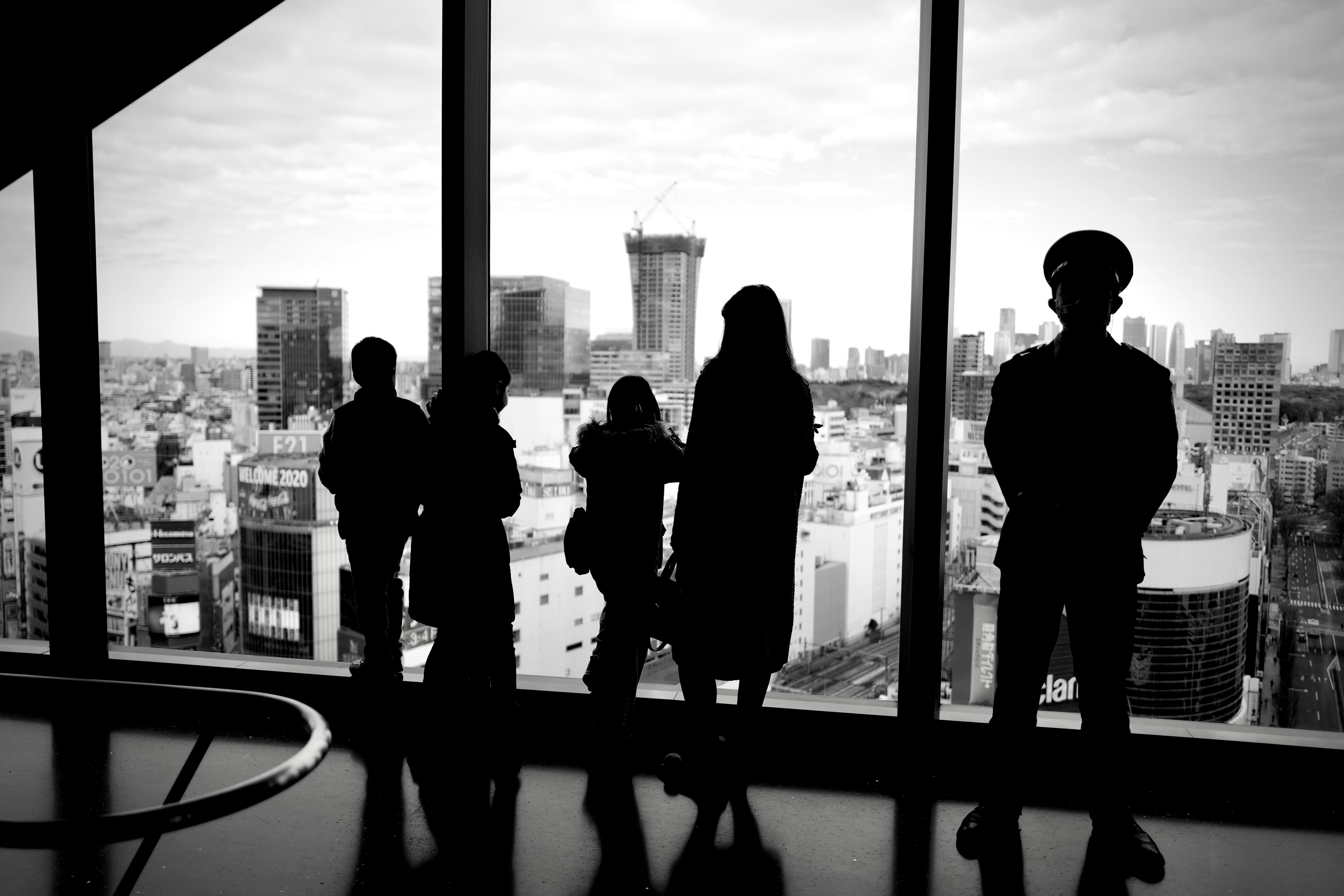 silhouette of people standing near window
